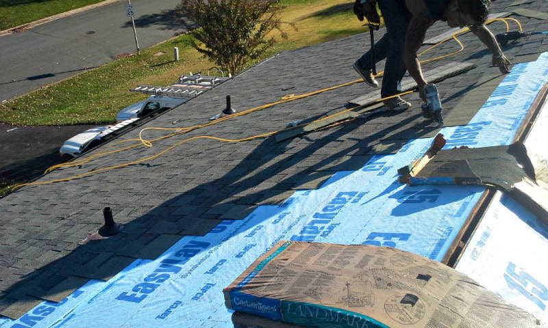 A roof installation in progress with professionals.