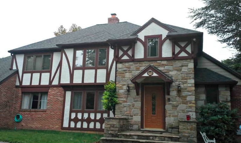 A photo of a house in Rockville with a gray roof and gutter system.