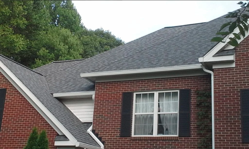 Roof with CertainTeed Landmark asphalt shingles and a white gutter system.