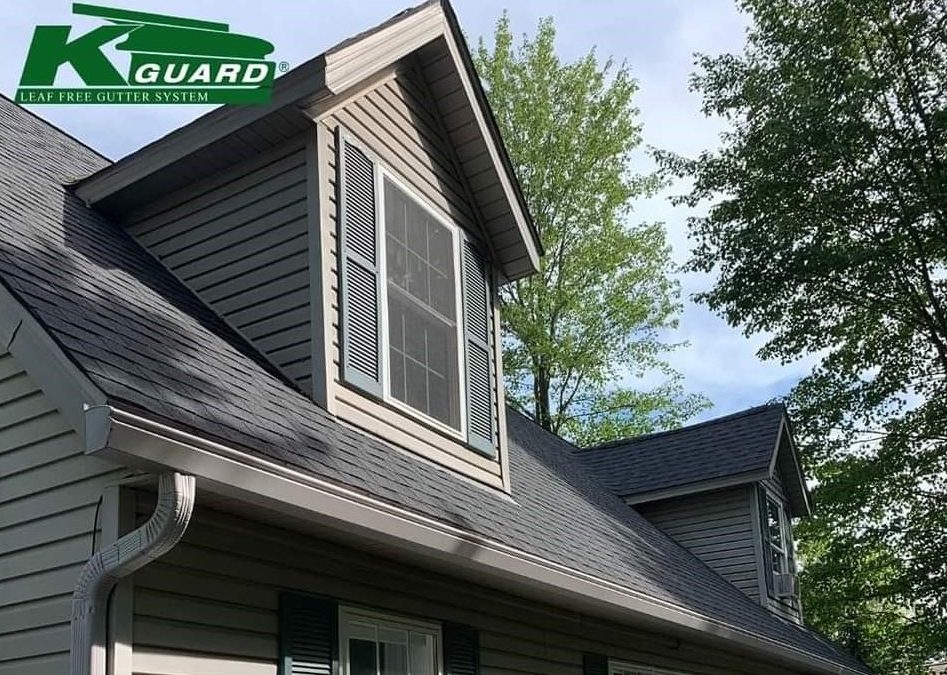 K-Guard Gutter System on a tan house with a slate shingle roof.